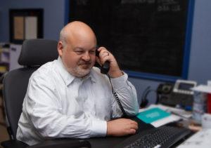 Attorney David Bressman at desk on phone