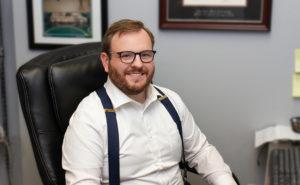 Jedidiah Bressman, Attorney, sitting at desk.