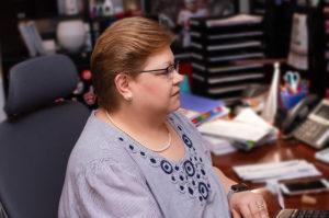 Karen Bressman - Paralegal, sitting at desk